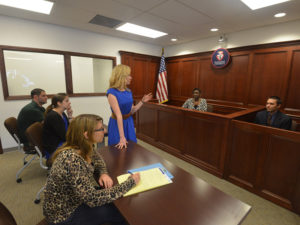 Students stand in a court room on Duquesne’s campus.