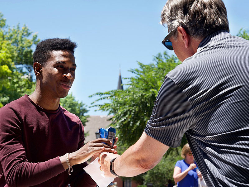 Photo of President Gormley handing out ice cream to student