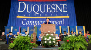 Duquesne University Commencement ceremony with Dean Ken Gormley at the podium.