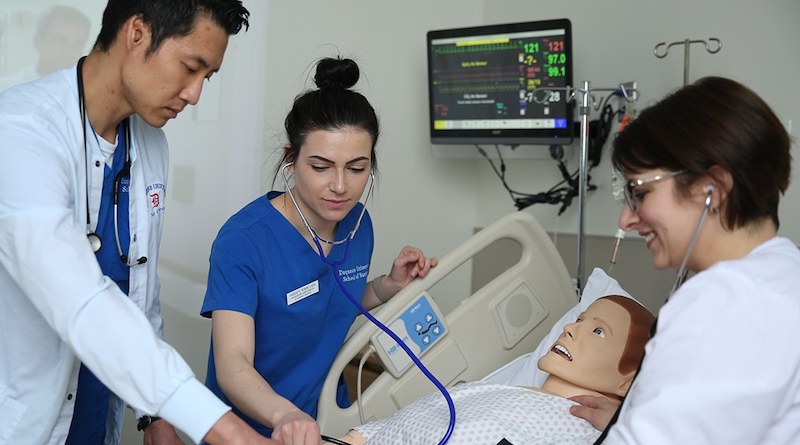 A photo of Duquesne Nursing students practicing on a test dummy